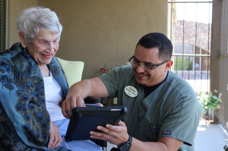 Sonora CNA works with resident on iPad